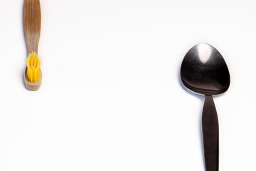 Wooden tooth brush and spoon in white background. Different sides
