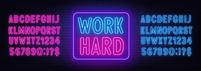 Work Hard neon lettering on brick wall background.