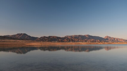 Beautiful red sea view with mountains and cloudy sky at dawn