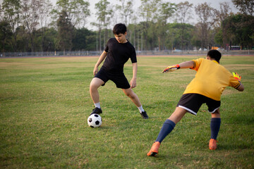 Sports and recreation concept two male soccer players attending regular practice sessions and memorizing attack and defense patterns