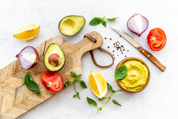 Homemade guacamole avocado dip with tomatoes and lime