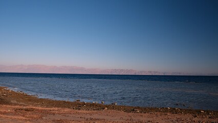 Beautiful red sea view with mountains and cloudy sky at dawn