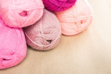 Vintage Knitting needles and yarn on wooden background. natural wool knitting background. knitting yarn for handmade winter clothes. Close Up of yarn balls. Rainbow colors. Place for text, banner.