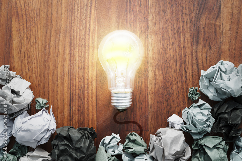 Poster failure is part of success. idea and success concept. lightbulb and paper ball.