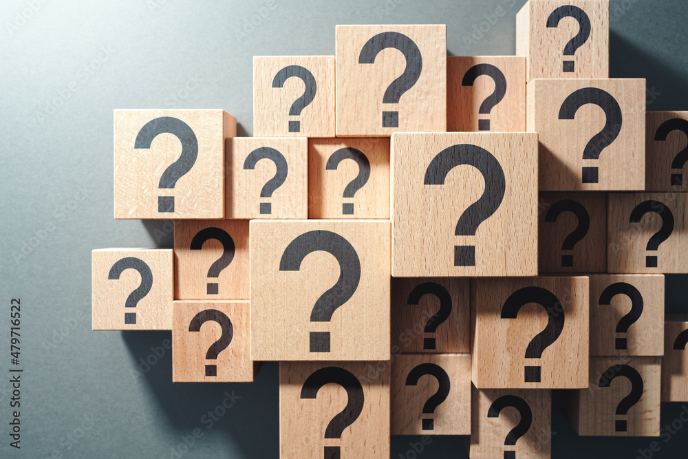 Poster Many question arising concept. Trouble and confusion. Top view of many wood cubes with question marks.