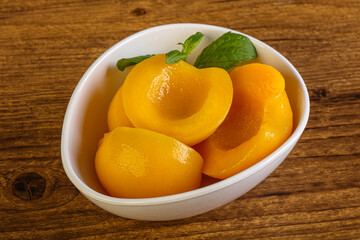 Sweet ripe canned peaches with mint