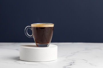 One glass coffee cup with espresso in morning on podium and white marble background. Aroma,...