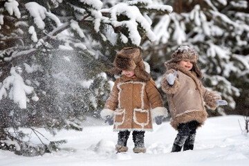 Two cute kids in winter Russian folk clothes like in a fairy tale