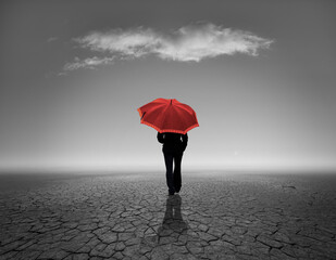 red umbrella - person walks in the desert