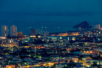 Fototapeta premium The high angle background of the city view with the secret light of the evening, blurring of night lights, showing the distribution of condominiums, dense homes in the capital community