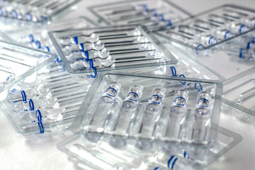 plastic transparent containers with glass ampoules on a white background