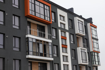 Obraz premium Fragment of Modern residential apartment with flat buildings exterior. Detail of New luxury house and home complex. Part of City Real estate property and condo architecture. Copy space