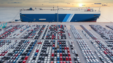 Aerial view vehicle carrier vessel loading car for shipping to worldwide, Large RoRo (Roll on/off) vehicle car carrier, New car lined up in the port for import export around the world. - obrazy, fototapety, plakaty