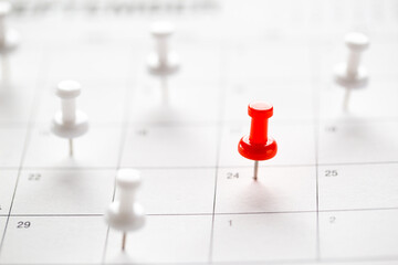 Calendar page pinned in a calender on datebusiness meeting schedule, travel planning or project milestone and reminder concept.