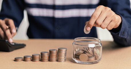 Businessman holding coins putting in glass. concept saving money for finance accounting.