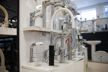 Kitchen faucets on shelf closeup, plumbing shop