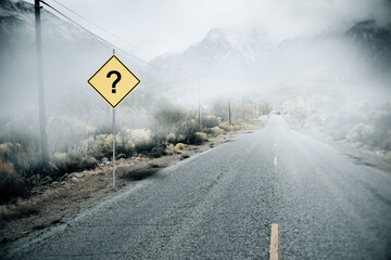 Creative misty road with question mark road sign and mock up place. Future and challenge concept.