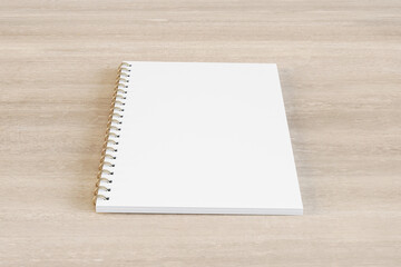 Close up of blank white spiral notepad on wooden desktop background. Mock up, 3D Rendering.