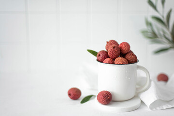 large ripe lychees fruit in a white mug