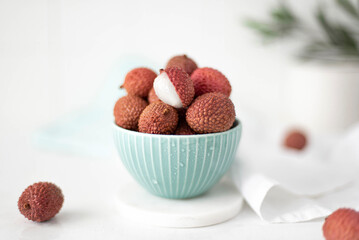 large ripe lychees fruit in a turquoise bowl