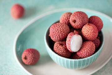 large ripe lychees fruit in a turquoise bowl