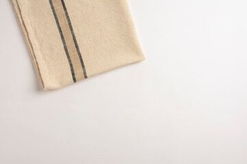 Fototapeta na wymiar Stripped kitchen towel isolated on white background. Top view of folded linen napkin isolated on white. linen napkin isolated on white background, top view. 