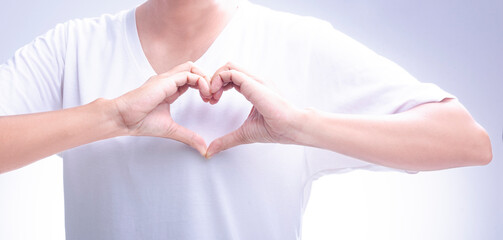 Woman making her hands in heart shape on a white isolated background. Loving the environment,...