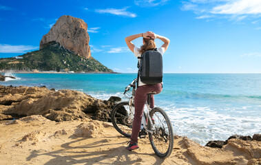woman with bike enjoying view of mediterranean sea- Calp,  Costa brava in Spain