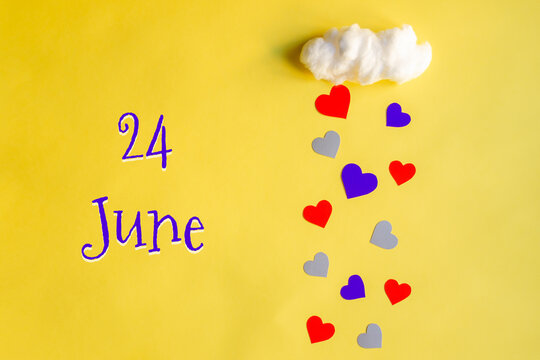 24 june day of month, colorful hearts rain from a white cotton cloud on a yellow background. Valentine's day, love and wedding concept