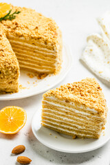 Almond honey cake sour cream frosting on plate. Space for text.