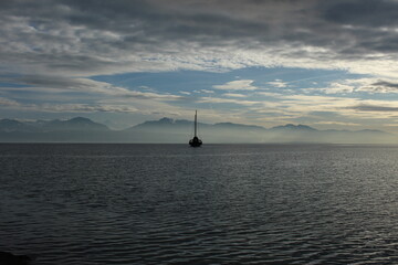 Ship at sea with mountain horizon
