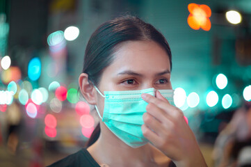 Beautiful woman wearing a surgical mask outdoor, covid-19 , health and pollution concept..