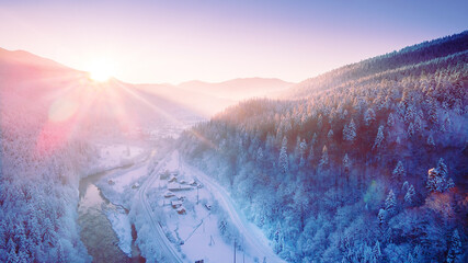 Stunning sunrise over snowy mountains in the alps, norway, finland, ukraine, the sun's rays...
