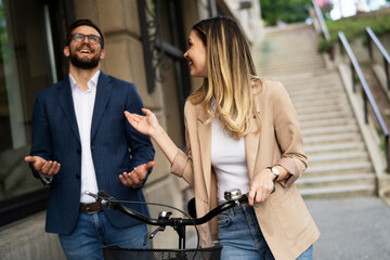 Young businesswoman and businessman standing on the street Beautiful businesswoman with bicycle.