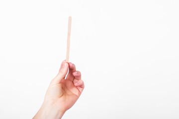 wooden stick for mixing coffee on white background. zero waste concept. replacement for plastic cups