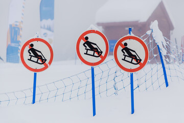 prohibitory sign on the ski slope, sledding is prohibited.
