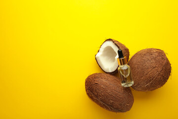Coconut oil with coconut on yellow background. Top view