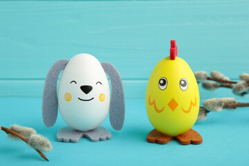 Easter holiday concept with cute handmade eggs, chicks and bunny on blue background.
