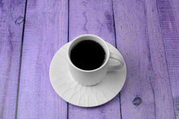 Cup with coffee on a saucer on a colorful bright background. Top and side view. The concept of relaxation, rest, tea drinking.