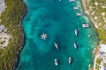 Aerial view of anchored sailing yacht in emerald Caribbean sea, Stocking Island, Great Exuma,...