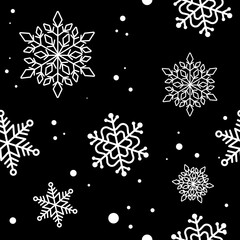 seamless pattern of white snowflakes on a black background