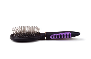 Massage comb for combing women's hair. Plastic brush with metal corners for detangling hair. On an isolated white background. Close-up.