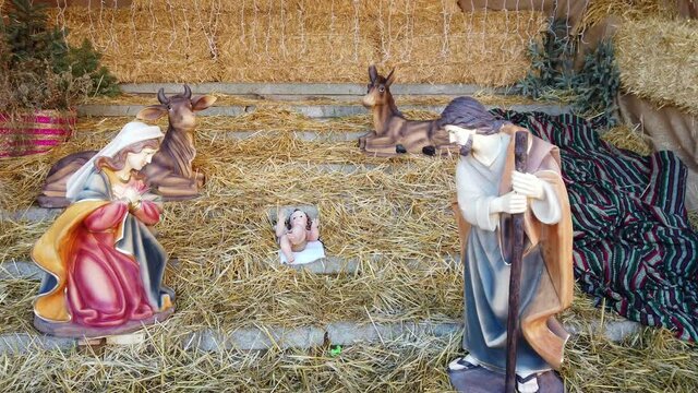 Christmas nativity scene with statue of Jesus and Wise Men in adoration - Catholic Christmas party