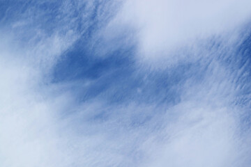 Amazing white altostratus clouds spreading across vibrant blue sky - obrazy, fototapety, plakaty