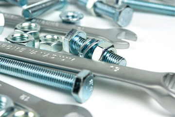 several open-end metal wrenches for working with bolts. Close-up on a white background. Silver...