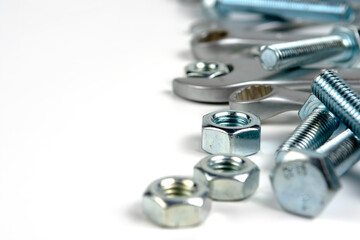 several open-end metal wrenches for working with bolts. Close-up on a white background. Silver metal fixing bolts and nuts. Copy space