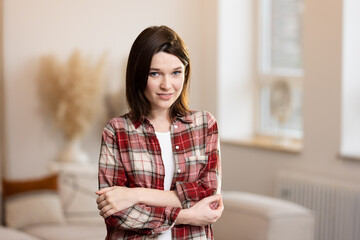 Smiling young business woman in modern office looking confident into the camera