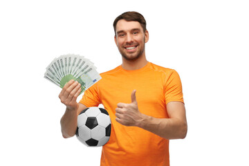 sport, leisure games and online betting concept - happy smiling man or football fan with soccer ball and money showing thumbs up over white background