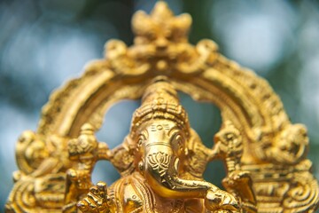 close up of lord ganesha golden statue