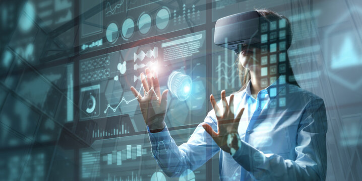 Businesswoman in vr glasses touching graphs on a virtual screen with HUD interface. Internet of things and futuristic technologies concept. Mixed media..